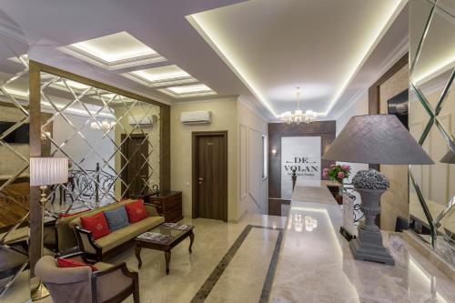 a living room with a couch and a table at De Volan Boutique Hotel in Odesa