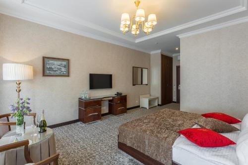 a hotel room with a bed and a desk at De Volan Boutique Hotel in Odesa