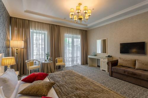 a hotel room with a bed and a couch at De Volan Boutique Hotel in Odesa