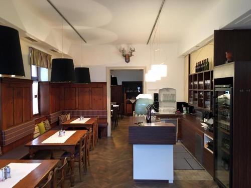 a large kitchen with wooden tables and a kitchenasteryasteryasteryasteryasteryasteryastery at Kirchenwirt Dependance Südsteiermark in Ehrenhausen