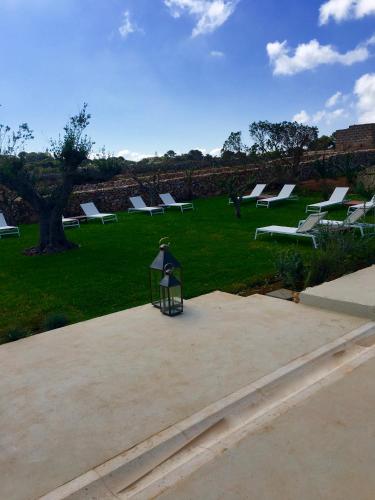a group of benches sitting in a park at Il Baglio sull'Acqua in Favignana