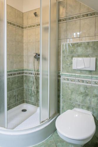 a bathroom with a shower and a toilet and a tub at Penzion Monika in Hrušovany nad Jevišovkou