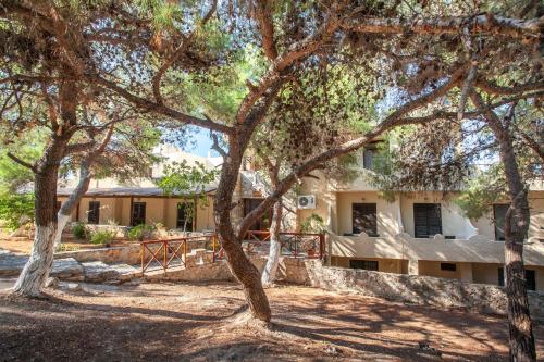 a house with trees in front of it at Hotel Abatis in Skala