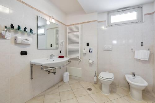 a white bathroom with a sink and a toilet at Best Western Hotel Rocca in Cassino