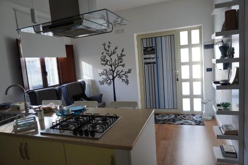 a kitchen with a stove top oven in a room at Lucky's Home in Enna