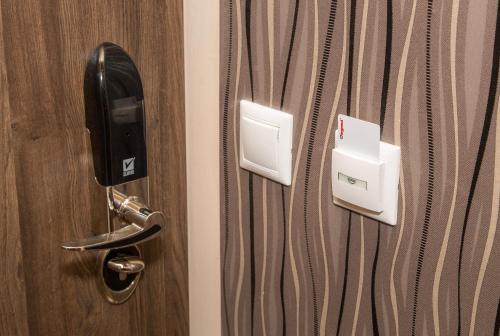 a hotel room door with a pay phone on it at Cantry Ételbár in Balkány