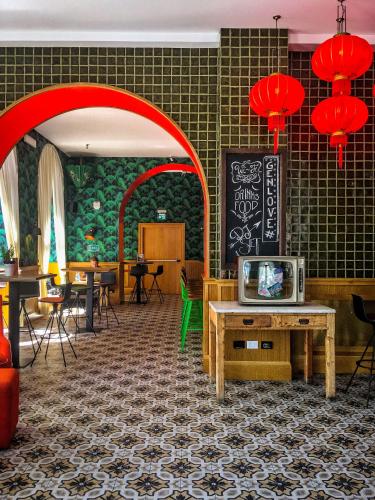 a restaurant with a table with a tv on it at Generator Rome in Rome
