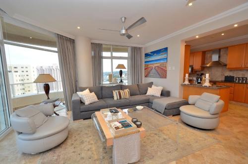 a living room with a couch and a table at 703 Oyster Schelles - by Stay in Umhlanga in Durban