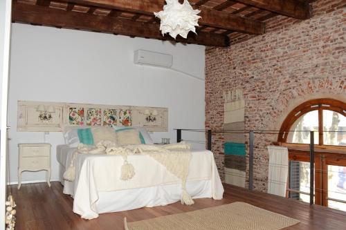 מיטה או מיטות בחדר ב-Las Glicinas Boutique Apartments