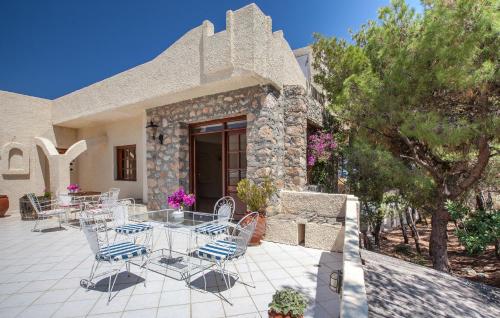 a patio with chairs and tables in front of a building at Hotel Abatis in Skala