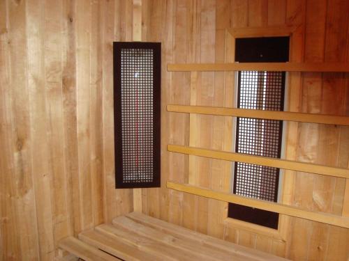 a room with wooden walls and a window and shelves at Hotel Kardjali in Kŭrdzhali