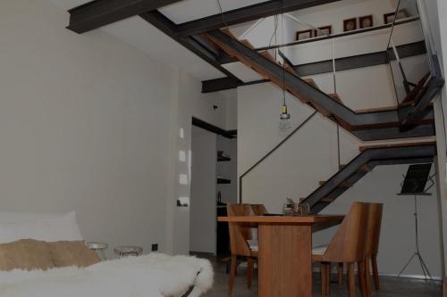 a dining room with a wooden table and chairs at Las Glicinas Boutique Apartments in Colonia del Sacramento