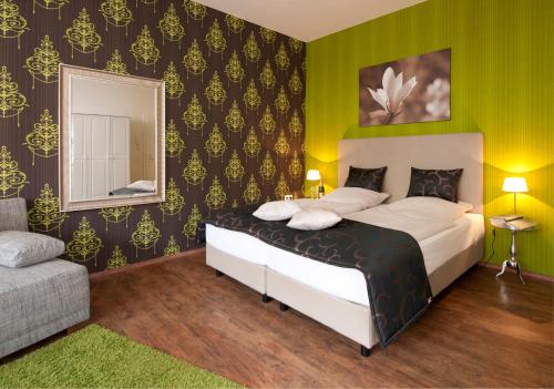 a bedroom with a bed and a mirror at Arthotel ANA Residence Bremen in Bremen