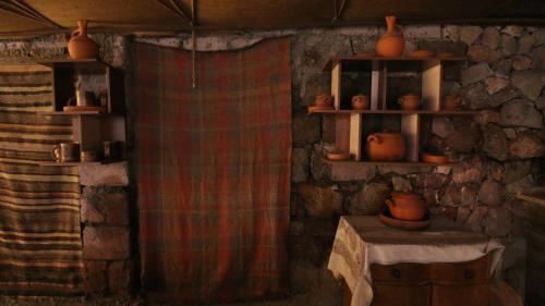 a room with a shower curtain and a table and shelves at Holiday home Golovino in Dilijan
