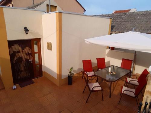 a balcony with a table and chairs and a building at Casa Albert in Constanţa