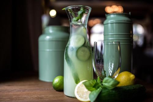 a drink in a glass vase with lemons and lime at Grand Hotel Stamary in Zakopane