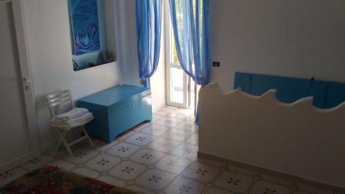 a room with a blue cabinet and a door with a window at Villa Glicine in Ponza