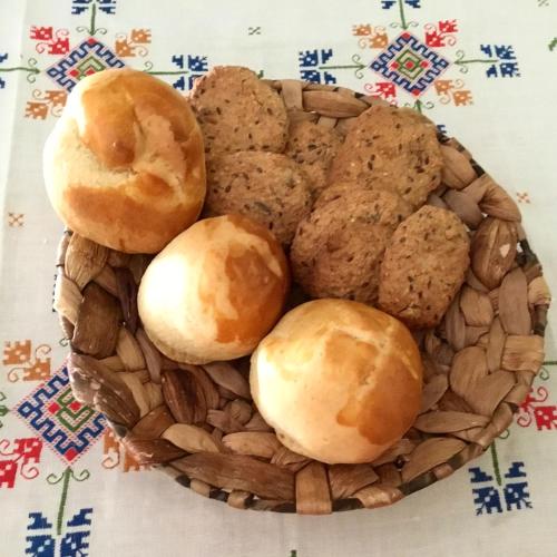 a basket of rolls and donuts on a table at Hostal Pirineos in Barbastro