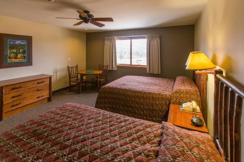 a hotel room with two beds and a window at YMCA of the Rockies in Estes Park