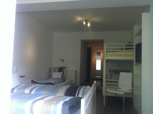 two beds in a room with a bunk bed at Bed & Breakfast BonnaNotte in Essen