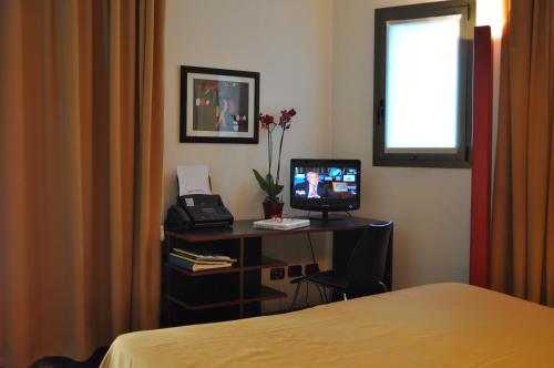 TV a/nebo společenská místnost v ubytování Residence Le Corti