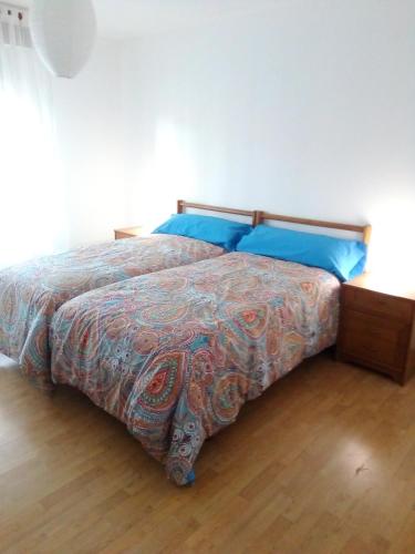 a bedroom with a bed with blue pillows at Casa Josefina in Armunia