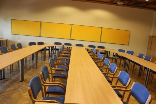 a long table and chairs in a conference room at Vitalhotel Marienhof in Velden am Wörthersee