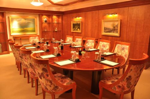 a conference room with a long wooden table and chairs at Shenzhen Sunshine Hotel, Luohu in Shenzhen
