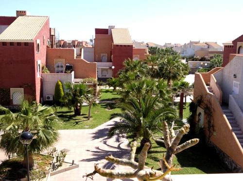 a view of a city with palm trees and buildings at Urbanizacion Naturista La Menara in Vera