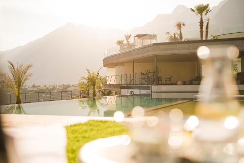 a view of a house with a swimming pool at Boutique Hotel Eschenlohe in Schenna