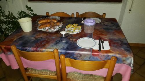 a table with a table cloth with food on it at Scano Comfort Inn in Santa Teresa Gallura