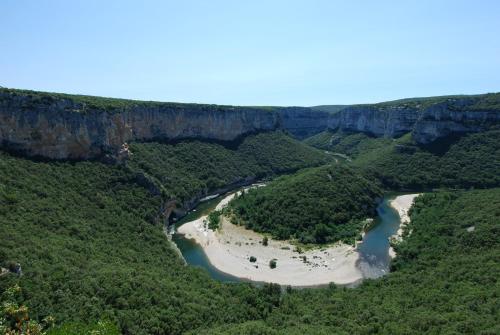 an aerial view of a river in a canyon at Cairenou Location in Saint-Martin-dʼArdèche
