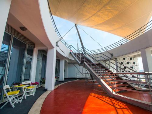 a staircase in a building with a table and chairs at IDRO Studio Apartments directly at the beach in Split