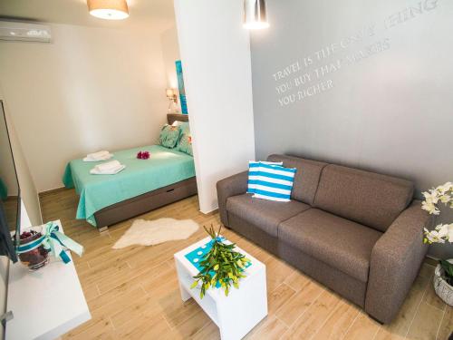 a living room with a couch and a bed at IDRO Studio Apartments directly at the beach in Split