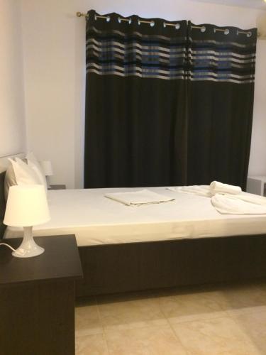 a bed in a room with a black curtain at Vilele Liliana in Mamaia Sat/Năvodari