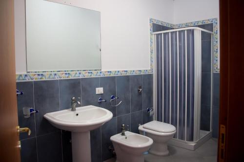 a bathroom with a sink and a toilet at Case Vacanza Torre Lupa in Marsala
