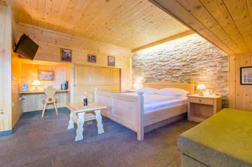 a bedroom with a bed and a table in a room at Penzion Berc in Bled