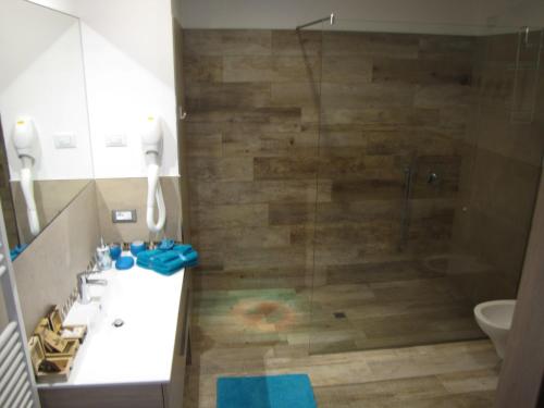 a bathroom with a shower with a sink and a toilet at Residence Villa Margherita in Brenzone sul Garda