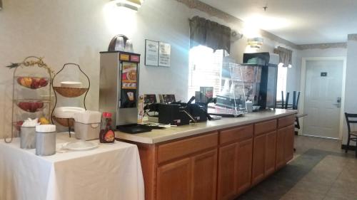 a kitchen with a counter top with two tables at Inn at Cemetery Hill in Gettysburg