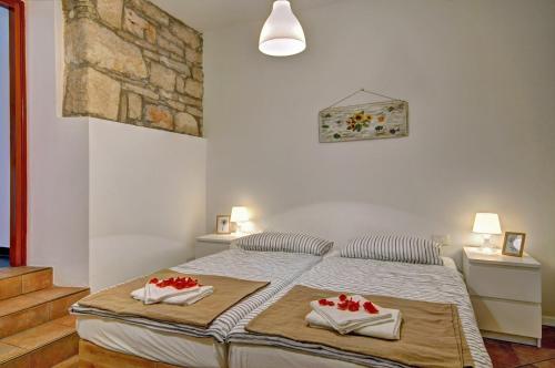 a bedroom with a bed with two towels on it at Apartman Amfiteatar Franko in Pula