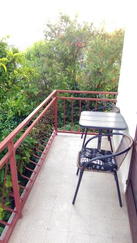 a bench sitting on top of a balcony at Apartments Petković in Kučište