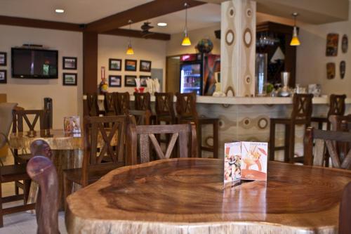 a restaurant with a wooden table and chairs at Manglar Lodge in San Carlos