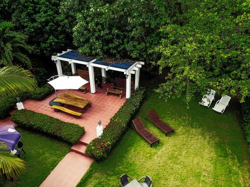 an overhead view of a patio with chairs and an umbrella at Manglar Lodge in San Carlos