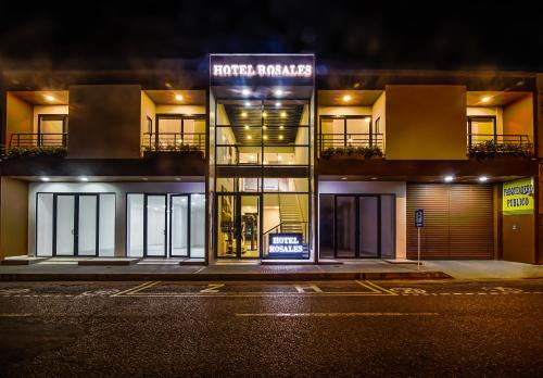 a store front of a building at night at Hotel Rosales Boutique in Neiva