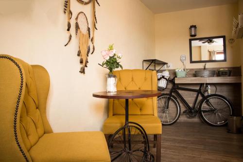 a room with a table and two chairs and a bike at Hotel & Spa La Mansion del B Azul in Querétaro