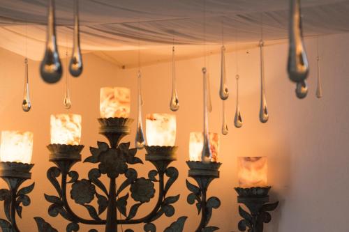 a group of lights hanging from a wall at Hotel & Spa La Mansion del B Azul in Querétaro