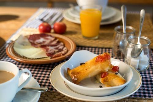 a table with plates of food and a cup of coffee at Marakasa B&B in Sant Antoni de Calonge