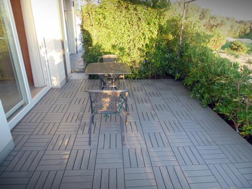a table and chair sitting on a patio at House Natali 70m from the beach - free EV top up in Rtina