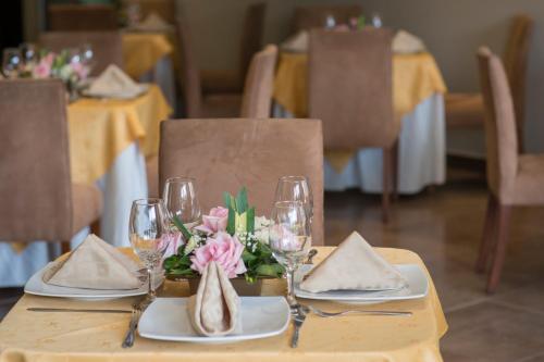 a table with wine glasses and flowers on it at Hotel Los Almendros in Manta