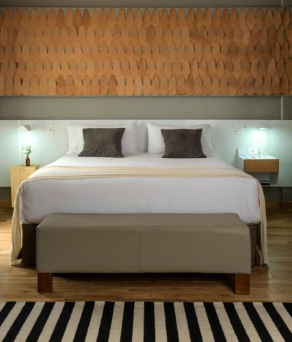 a bedroom with a large bed with a wooden wall at Hotel Arenales in Buenos Aires